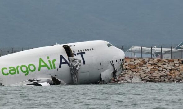Cargo plane slides off runway in Hong Kong, killing two airport staff