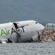 Cargo plane slides off runway in Hong Kong, killing two airport staff