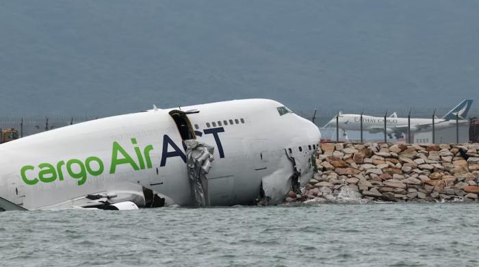 Cargo plane slides off runway in Hong Kong, killing two airport staff Cargo plane slides off runway in Hong Kong, killing two airport staff