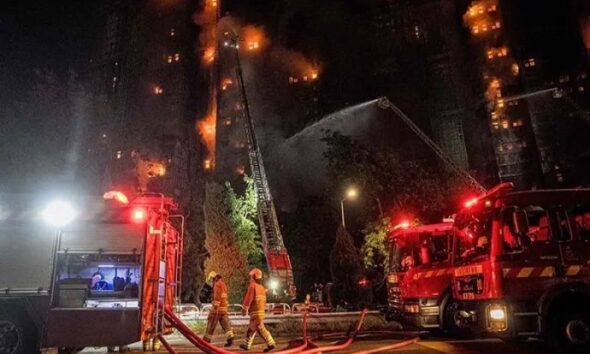 Fire engulfs Hong Kong residential buildings killing at least 14 people, trapping others