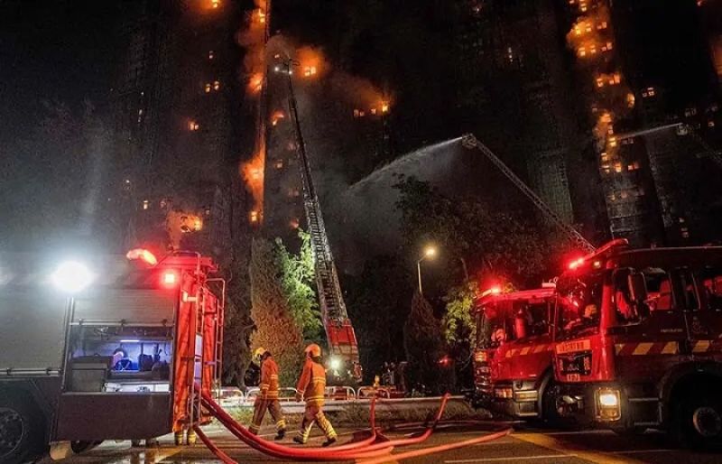 Fire engulfs Hong Kong residential buildings killing at least 14 people, trapping others