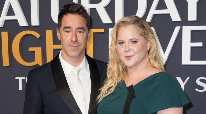 Amy Schumer, Chris Fischer still living together post split