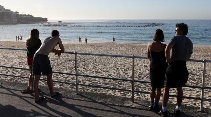Australia plans gun buyback after Bondi massacre, as surfers honour victims