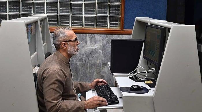 PSX hits record high on UAE rollover optimism