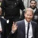 Prince Harry waves and receives good luck cheers on day two of trial