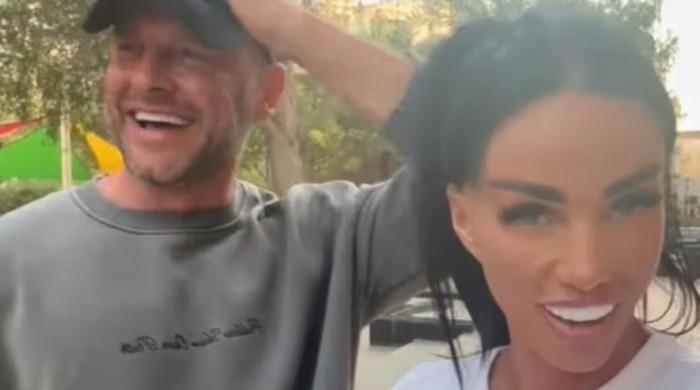Katie Price laughs off pregnancy claims as Lee Andrews remains overseas
